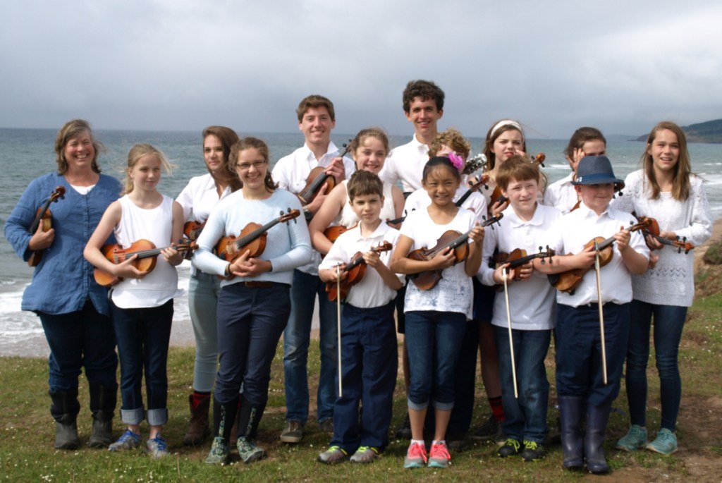 The Pineland Fiddlers front from left, are Ellen Gawler, Mari Averill, Eleanor Skinner, Silas Bartol, Lily Thompson, Elijah Huttman and Owen Kennedy. Back from left are Alex Frost, Lucas Lenfast, Sedona Kmen, Luke Bartol, Joshua Rosenthal, Pyper Birch, Gwinna Remillard and Lydian Frost.