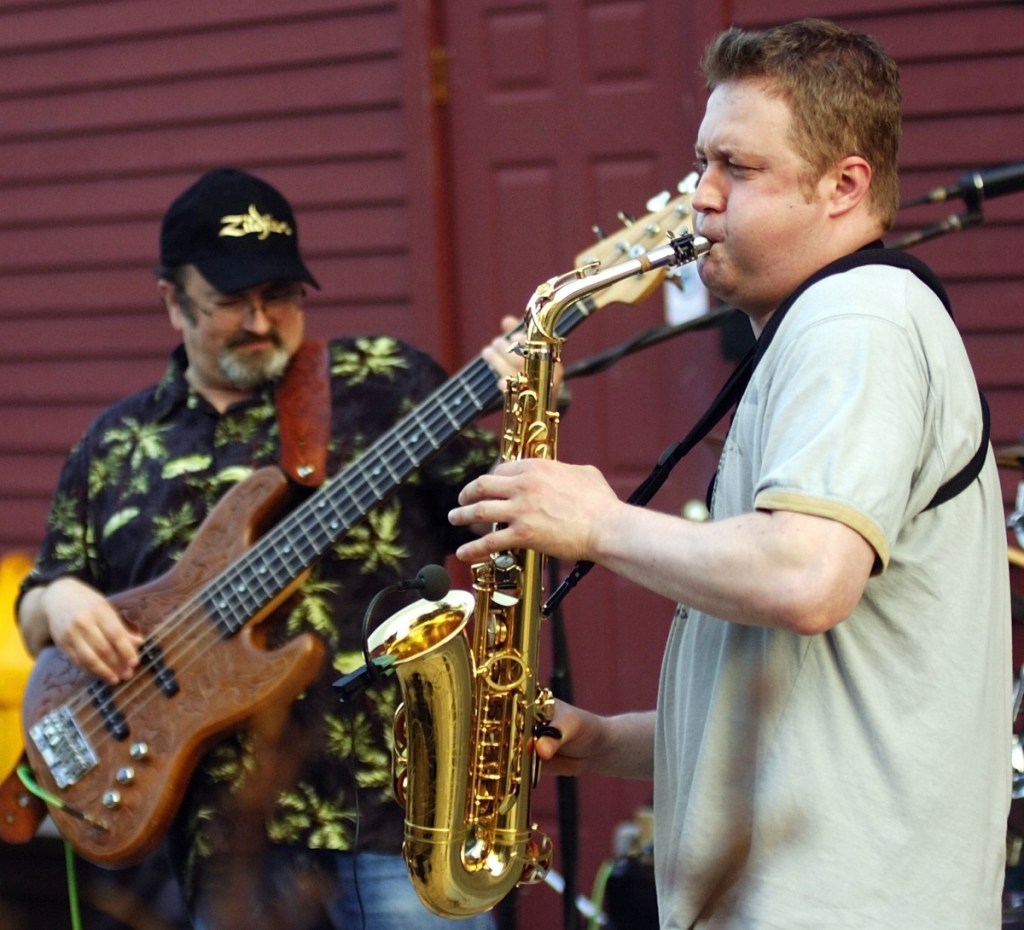 David Thibodeau, left, plays bass while Darren Whitney blows a saxophone solo as their group R&B 3D plays July 28, 2009, on the bandstand at the corner of Water and Winthrop Streets in Hallowell.