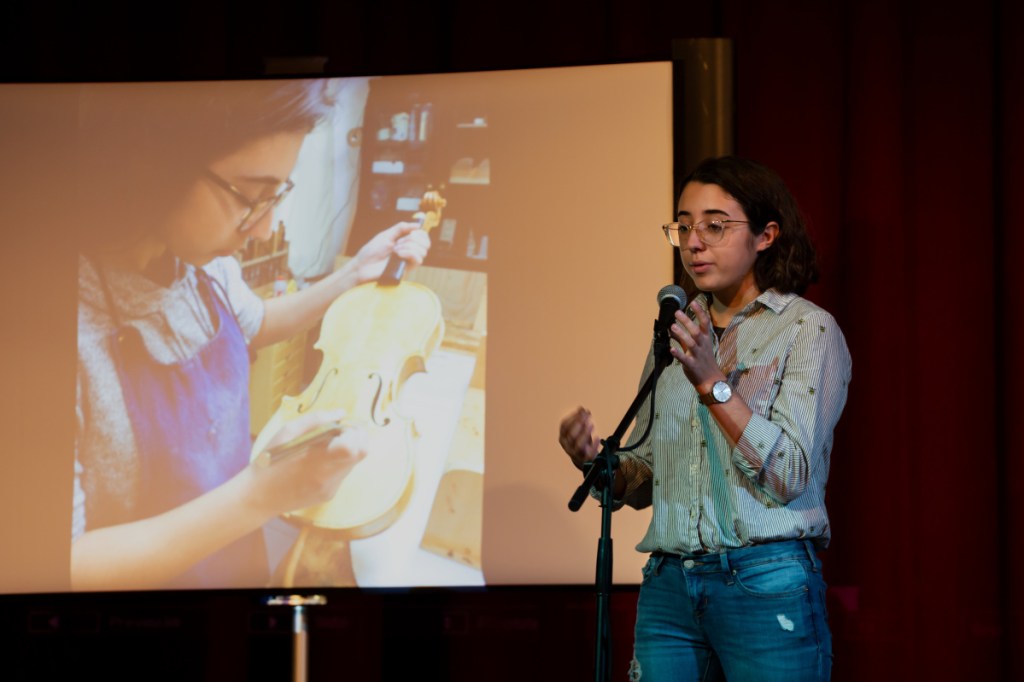 Anna Schaab takes the stage in the Hallowell City Hall auditorium on Sunday to explain to attendees how she constructed her own violin. Schaab ended her presentation with a live performance. The second annual Maine Luthier Exhibition & Music showcase took place in Hallowell at multiple venues this weekend.