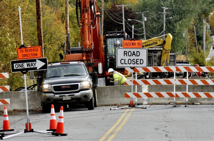 Workers and equipment near the bridge on the closed Causeway Road in China on Tuesday.