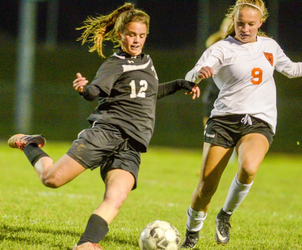 Maranacook's Kaylee Jones, left, tries to pass the ball around  Winslow's Alison Stabins during a game Tuesday in Readfield.