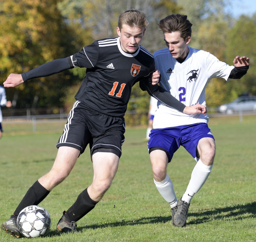 Gardiner's Casey Bourque, left, fights for position with John Bapst's Connor Reese during a Class B North prelim game Friday  in Gardiner.