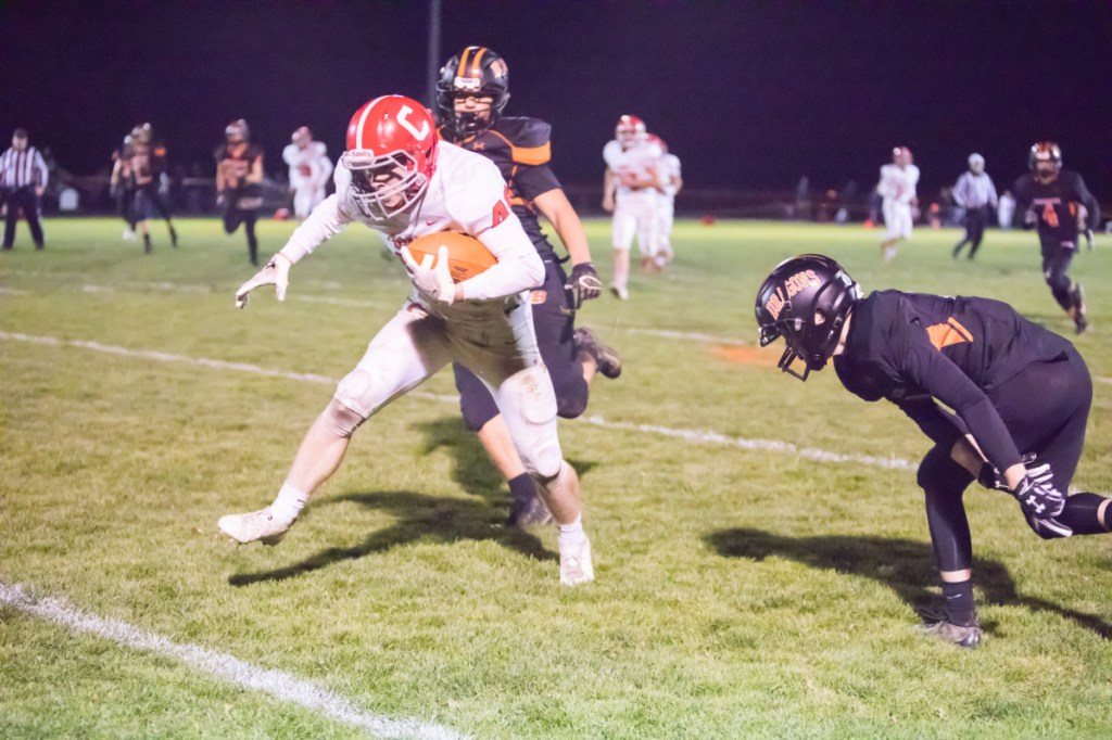 Cony's Matt Wozniak is chased down by Brunswick's Hunter Backhaus and Noah Goddard on Friday night in Brunswick.