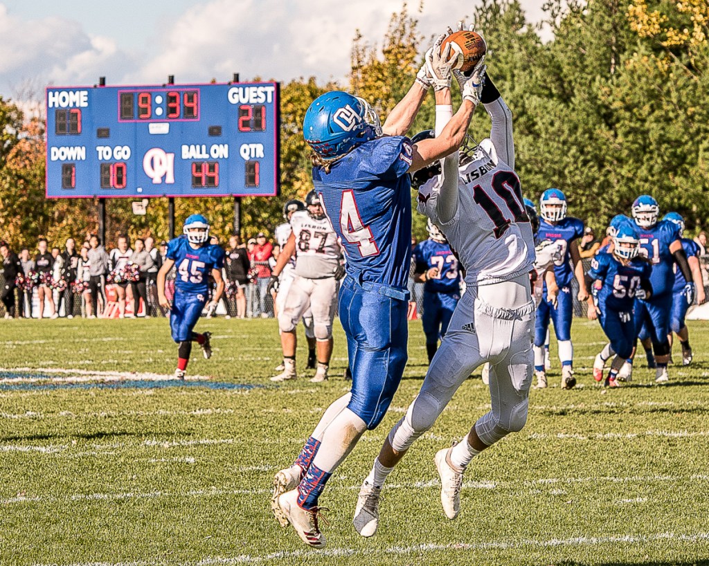 Oak Hill's Sam Lindsay and Lisbon's Seth Leeman both leap for a ball intended for Linsday in the first quarter Saturday in Wales. The ball was dropped.