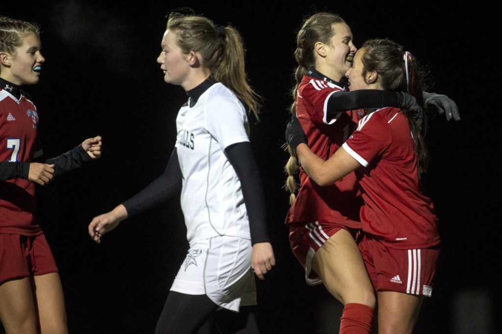 Staff photo by Michael G. Seamans 
 Messalonskee's Caitlin Parks, right, celebrates her first half goal with teammate Anika Elias during a Class A North quarrerfinal game against Oxford Hills on Tuesday night at Thomas College.