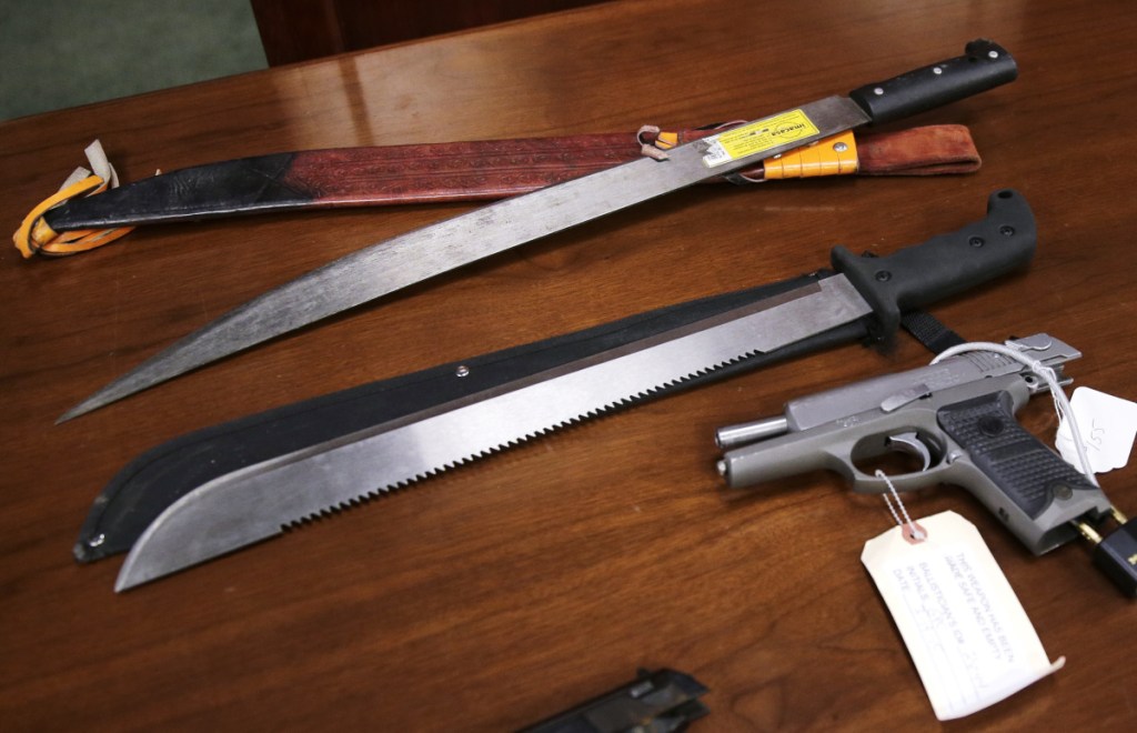 Weapons are displayed at the U.S. Attorney's Office following the January 2016 arrests of dozens of MS-13 gang members in Boston.