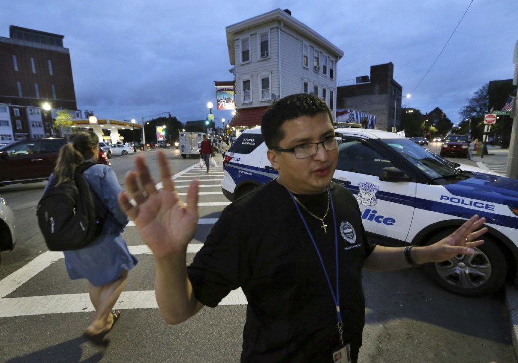 Francisco Melger of the Boston Center for Youths and Family speaks during a weekly peace march in East Boston last month. The neighborhood's streets are quieter since a 2016 takedown of MS-13 gang members, residents say.