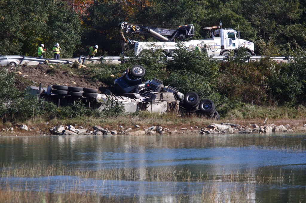 A tractor-trailer rollover on Interstate 295 southbound is seen from Presumpscot Street in Portland on Friday. The truck's milk and fuel had to be pumped out before the wreckage could be removed, police said.