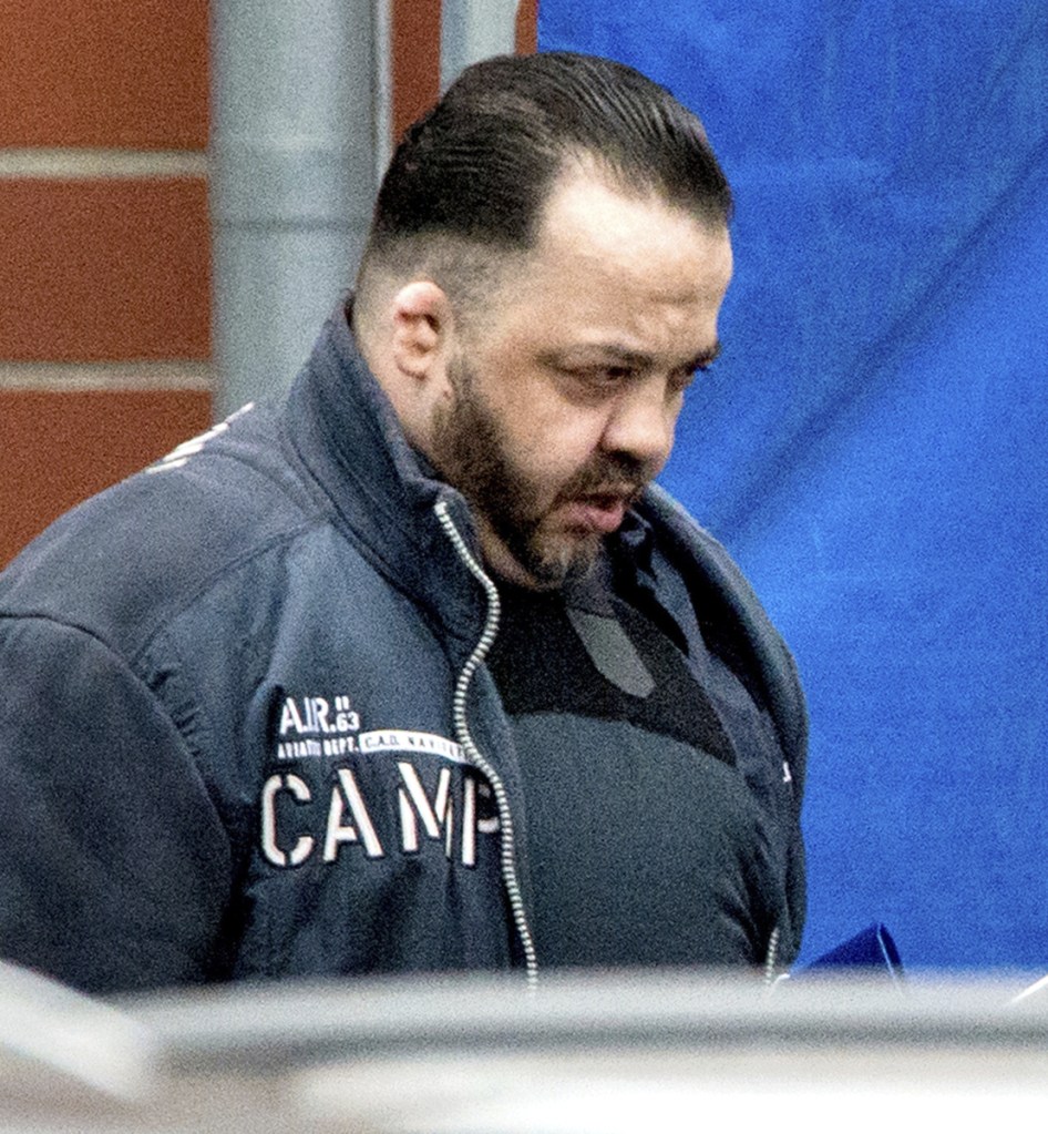 Niels Hoegel, 41, wears a bullet-proof vest as he leaves court Tuesday in Oldenburg, Germany.