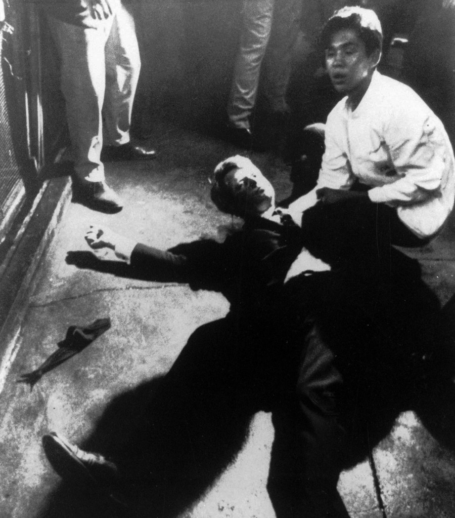 In this June 5, 1968 file photo,  Hotel busboy Juan Romero, right, comes to the aid of Senator Robert F. Kennedy,  as he lies on the floor of the Ambassador hotel in Los Angeles moments after he was shot.  The Los Angeles Times reported Thursday, Oct. 4, 2018, that Romero died Monday in Modesto, California, at age 68.  