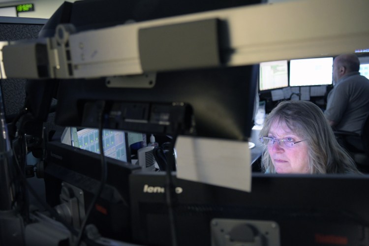 Department of Public Safety dispatchers communicate July 26 with firefighters, police and rescue workers at the Augusta agency.