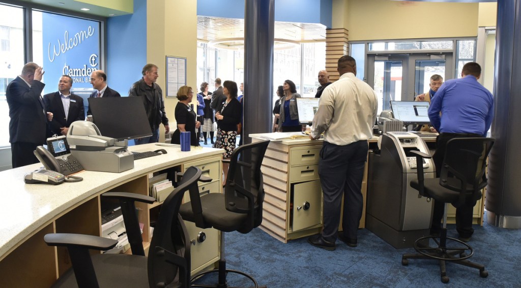 Customers are assisted as officials fill the lobby of the new Camden National Bank for a grand opening celebration Monday at the Bill & Joan Alfond Main Street Commons building in Waterville.