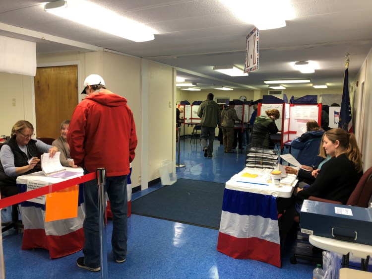 Deputy election clerks Julie Finley, left, Traci Britten and Aileen Pelkey, right, organize blank ballots Tuesday as China residents cast their votes at the portable building near the Town Office.