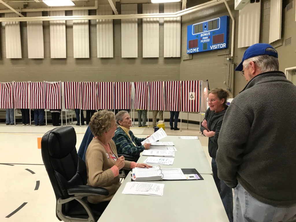 Fairfield election clerks Lynda Kinley and Patricia Shea hand out ballots to voters Tuesday during the election.