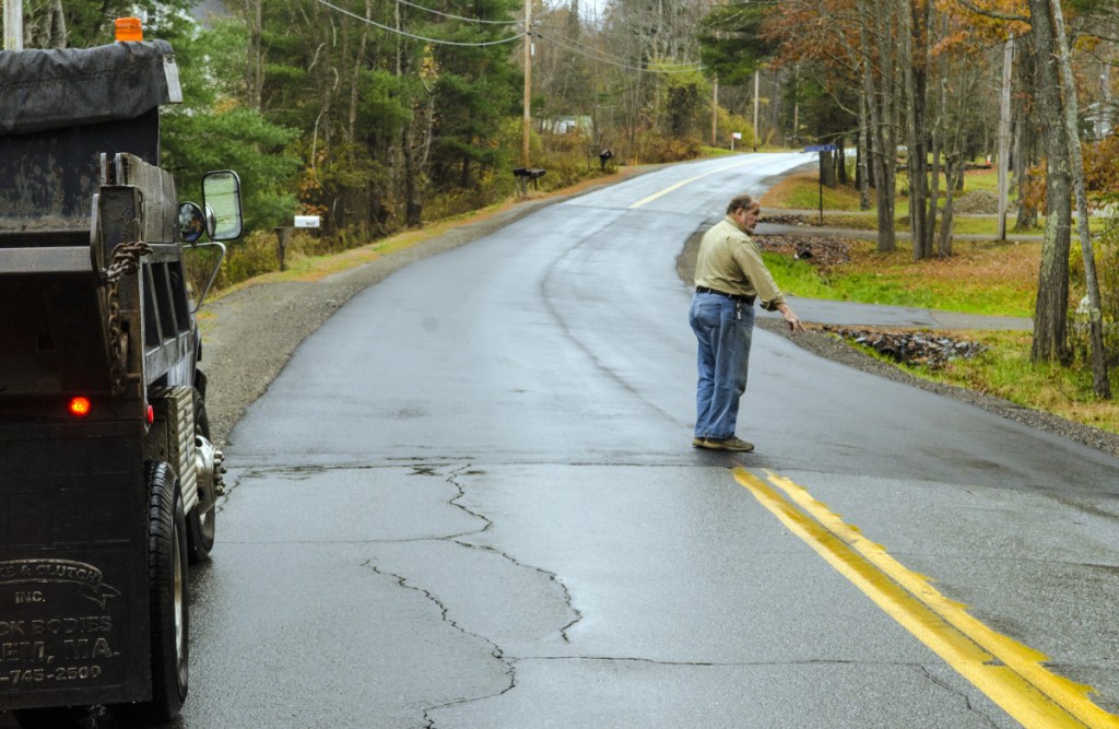 Farmingdale Road Commissioner Steve Stratton talks about the pavement level on a recently repaired section of Northern Avenue on Thursday in Farmingdale.