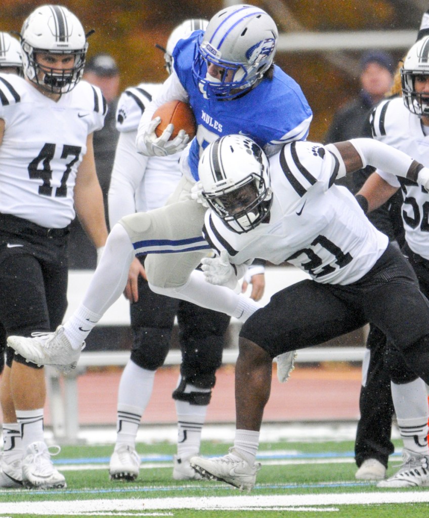 Colby's Ethan Smith, left, gets knocked out of bounds by Bowdoin's Matthew Williams on Saturday in Waterville.