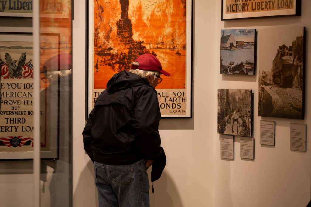 Mike Thompson, of Boothbay Harbor reads plaques in the "Over there and down home: Mainer's and World War I" exhibit in the Maine State Museum in Augusta on Sunday. Thompson was in attendance to view the exhibit and pay respect to his great-uncle who had died in "The Great War."