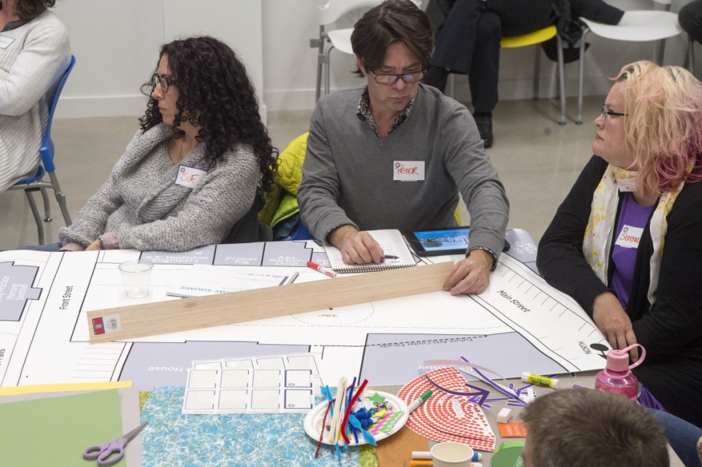 Members of the community gather on Wednesday at the Bill and Joan Alfond Commons as Neil Kittredge, an architect with Beyer, Binder and Belle, discusses design approaches for the new arts center and Castonguay Square during a community workshop.