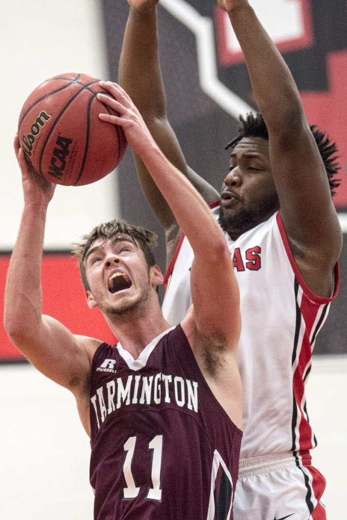 University of Maine at Farmington's Issac Witham (11) draws a foul from Thomas' Justin Butler during a game last season in Waterville.