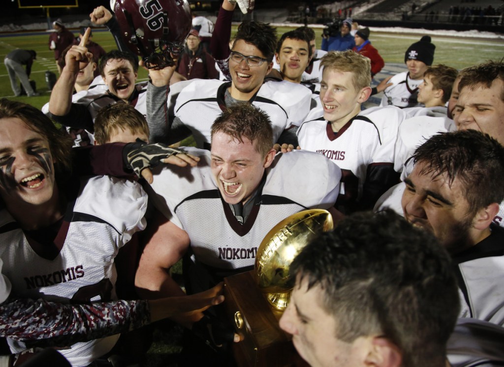 The Nokomis football team celebrates after winning the Class C state championship Saturday at Fitzpatrick Stadium in Portland.