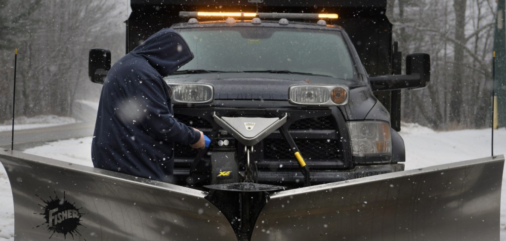 B.J. Robbins replaces fluid in a plow Tuesday at the Litchfield town garage as a snowstorm moves through the region. Plow operators were preparing equipment across Maine because several inches of fresh snow was predicted.