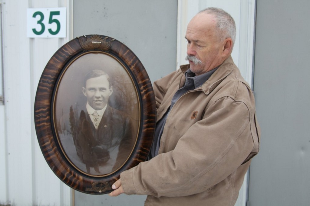 Windsor Historical Society President Robert Brann holds a portrait of Windsor's lone World War I fatality, Harold Sproul, on Nov. 19 outside the Windsor Museum.