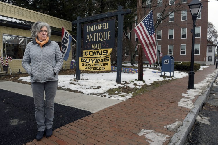 Hallowell Antique Mall owner Mercedes Knee stands on Monday next to the new sidewalk in front of her business.