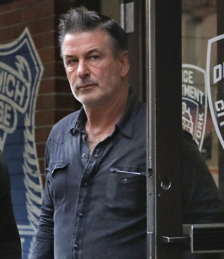 Actor Alec Baldwin leaves the New York Police Department's 10th Precinct on Friday.