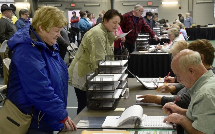 Waterville voters check in with election clerks before voting at Thomas College on Tuesday.