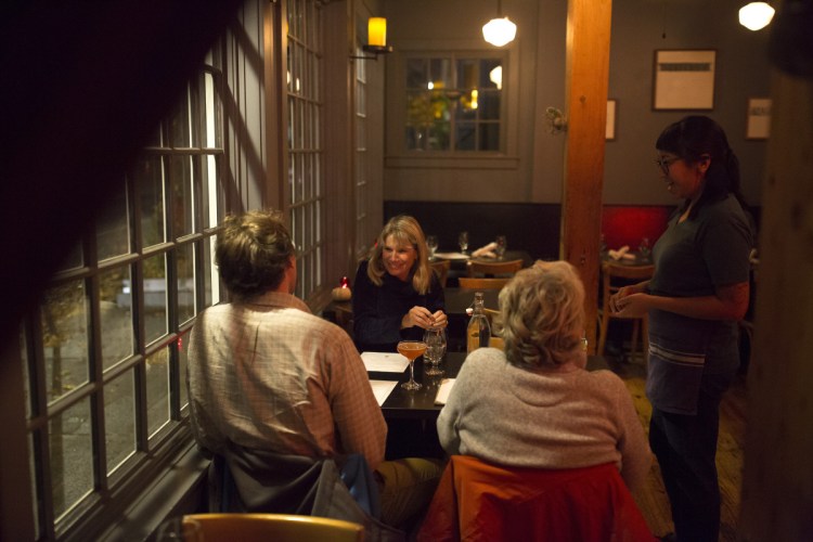 Blue Spoon server Sena Phin delivers drinks to, from left, Jack Riordan, Marcia Livada and Holly Riordan.