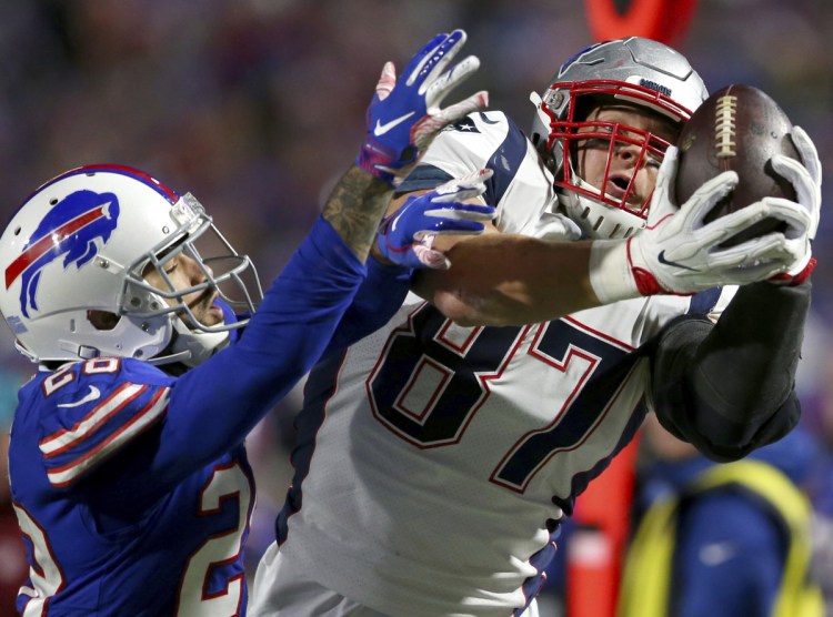 New England Patriots tight end Rob Gronkowski, right, is dealing with back and ankle injuries and is expected to miss Sunday's game at Tennessee.