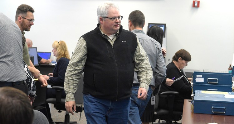 Secretary of State's Office employee Andrew Roth-Wells assists Monday November 12, 2018 counting ballots during a tabulation of votes for Maine's second congressional district race between Jared Golden and Bruce Poliquin in Augusta.