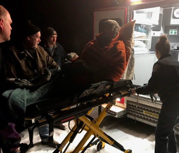 Donald Merrill is loaded into an ambulance after being rescued by game wardens on Westport Island on Nov. 19. 