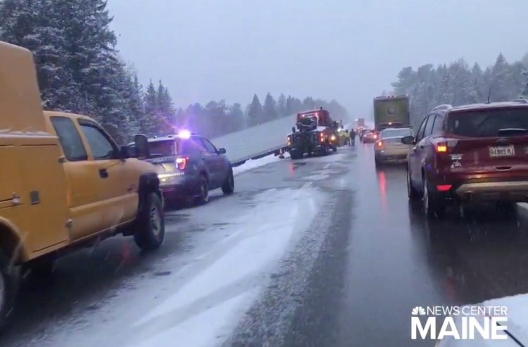 The truck that jackknifed on Interstate 95 Tuesday afternoon lies on its side. Drivers who tried to avoid the wreck when it happened began to slide on the slick pavement, with most ending up off the road.