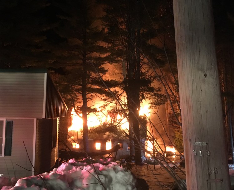 Fire consumes a house on Ben Gilpatrick Road in Hiram early Saturday. A 19-year-old man died in the fire.