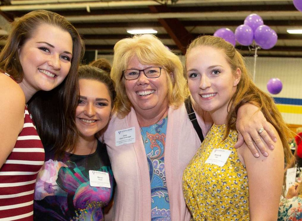 From left, student Olivia Riitano; Cary Olson Cartwright, assistant vice president for corporate social responsibility at Unum; and students Macee Pearl and Shanoah Hill meet at Piscataquis Community High School in Guilford.