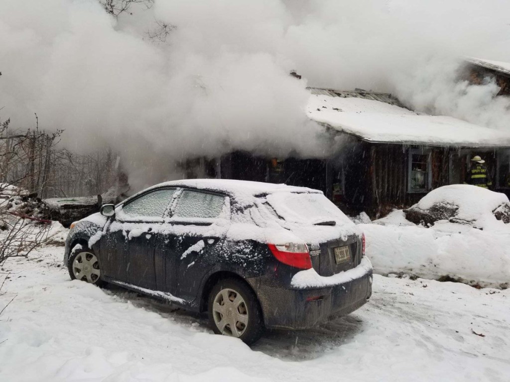 Firefighters battle a blaze that destroyed a home early Sunday on Pease Hill Road in Anson.