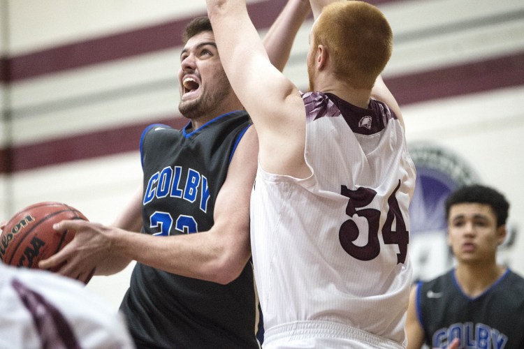 University of Maine at Farmington's Anthony Owens (54) defends Colby's Sean Gilmore on Tuesday in Farmington.