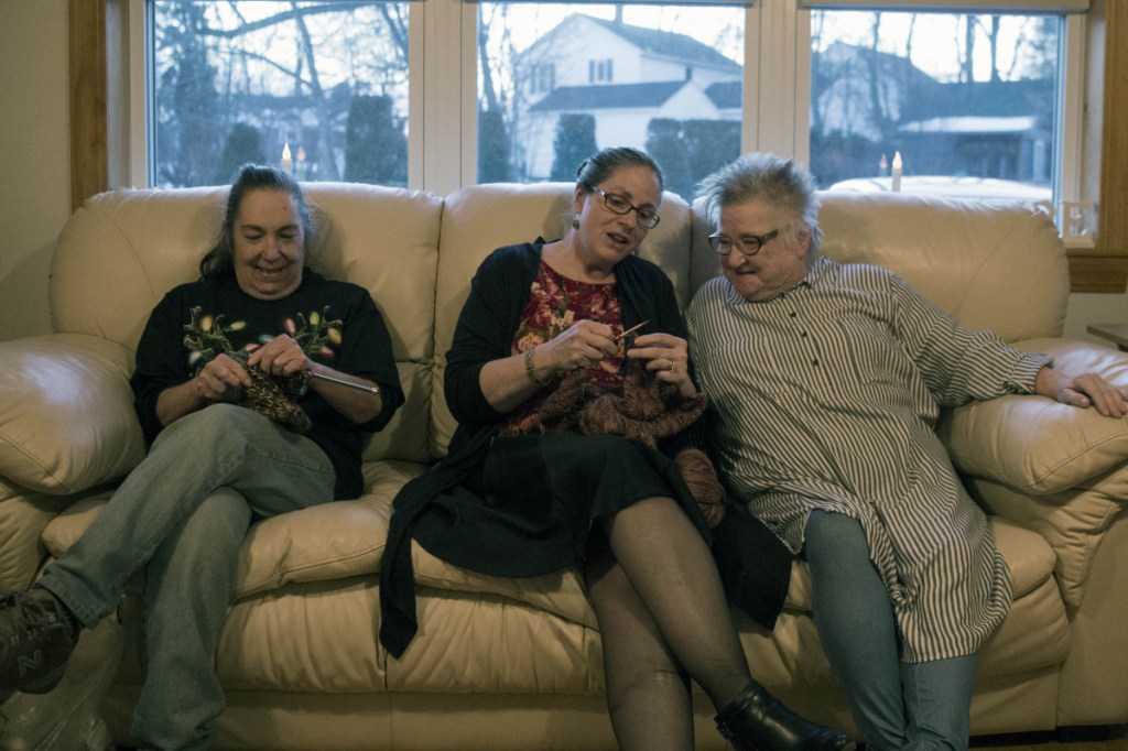 Martha Dempski, center, founder of the Women's Initiative, knits on Wednesday with members Pat Byther, right, and Criss Kraus, left, at the group's new location, 304 Main St. in Waterville.
