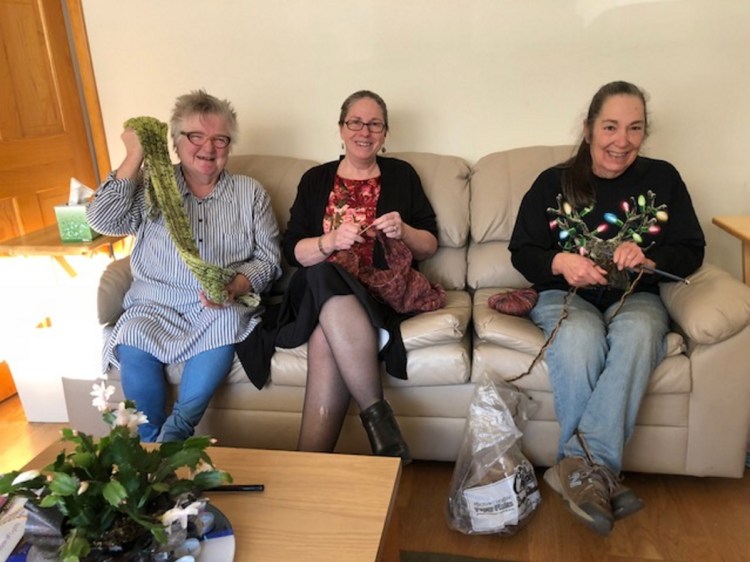 Women's Initiative founder Martha Dempski, center, and members Pat Byther of Winslow, left,  and Criss Kraus of Oakland, work on crafts Wednesday at the organization's new home at 304 Main St. in Waterville. It is sharing space at Hospice Volunteers of Waterville Area.