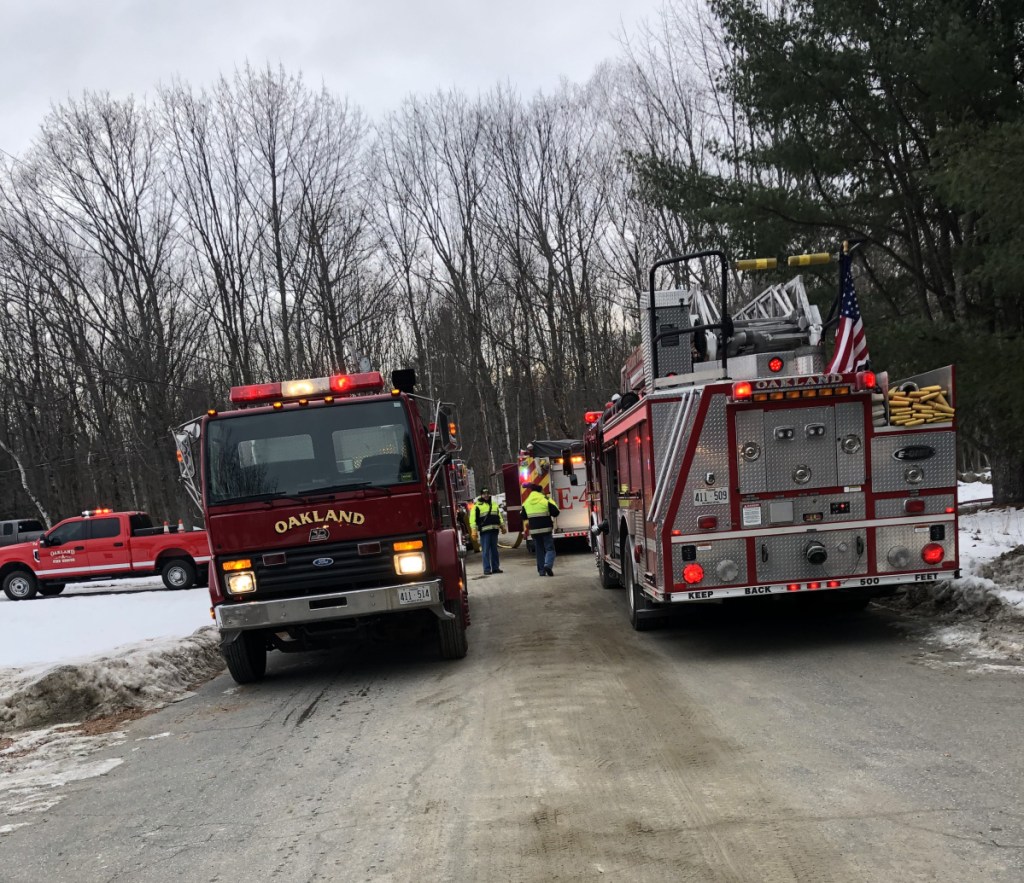 Oakland firefighters huddle on Thursday outside a residence at 25 Denise Ave., where a couple suffered smoke inhalation and minor injuries from a kitchen fire. Firefighters from Oakland, Belgrade, Rome and Sidney responded to reports of the fire, and Waterville firefighters stood by at the Oakland fire station.