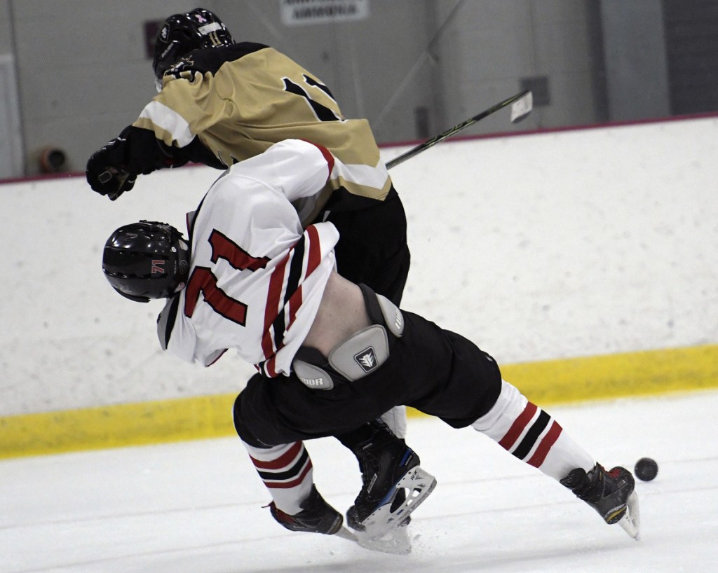 The Kings' Cole Gagne collects a penalty while connecting with the Hawks' Max Thamert during a game Monday in Readfield.