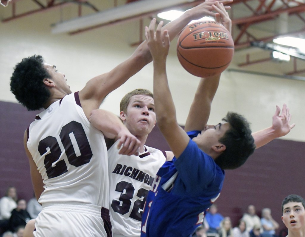 Richmond's Kenny Bing, left, and Dan Stewart block Oak Hill's D'Andre Daniels during a Mountain Valley Conference game Wednesday in Richmond.