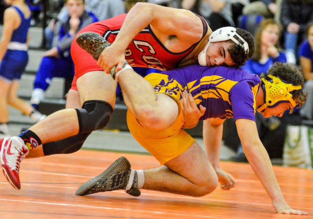 Cony's Nic Mills takes down Cheverus' Sebastian Merrill in the 195-pound semifinals Saturday in Gardiner.