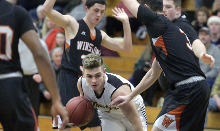 Maranacook's Mitchell Root finds his way under Winslow defenders during a Kennebec Valley Athletic Conference game Tuesday in Readfield.