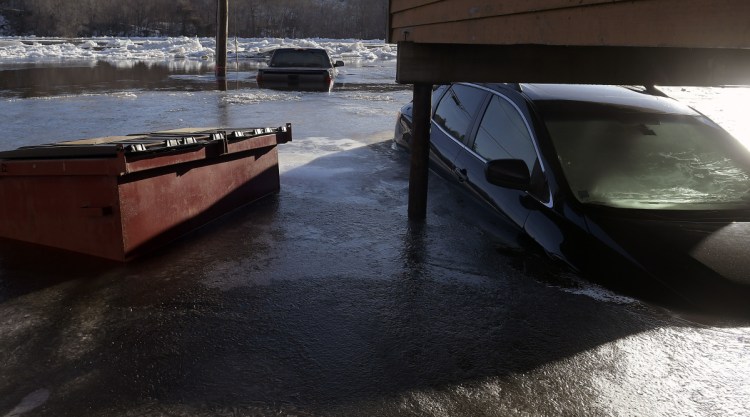 Cars stand submerged Jan. 14 in the Kennebec River in Hallowell after flooding in the early morning.