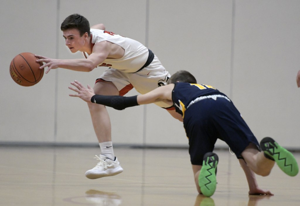 Cony's Kyle Douin, left, strips Mt. Blue's Jacob Farhnam of the ball during a Kennebec Valley Athletic Conference Class A game Thursday in Augusta.