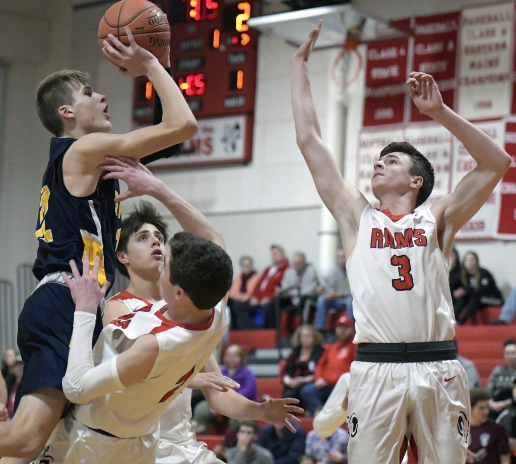 Cony's Dakota Dearborn defends Mt. Blue's Jacob Farhnam as he goes up for two during a Kennebec Valley Athletic Conference game Thursday in Augusta.