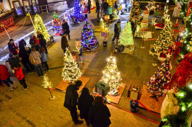 People put tickets in boxes for a chance to win the trees and prizes during River to Trees event Nov. 24 in the Colonial Theater in downtown Augusta.