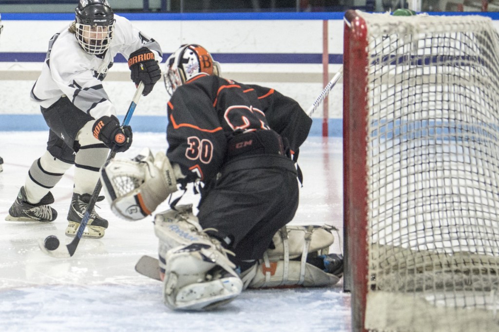 Kennebec's Tommy Tibbetts (91) puts a shot on Brewer goalie Tyler St. Lawrence (30) in the second period Wednesday at Colby College in Waterville.